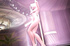 Short-haired blonde dancer performing strip dance at the pole